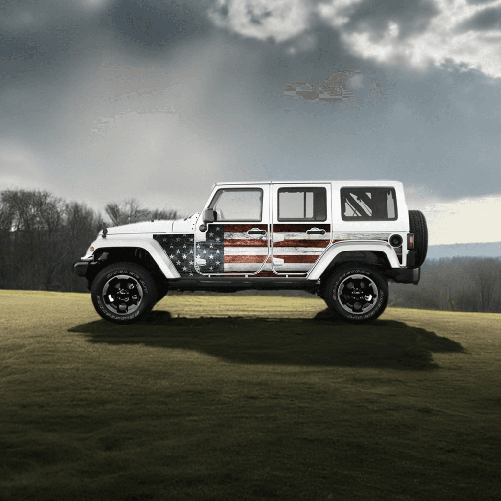White Jeep Wrangler JKU with MEK removable trail armor featuring an American flag design, parked on a grassy field under a cloudy sky.